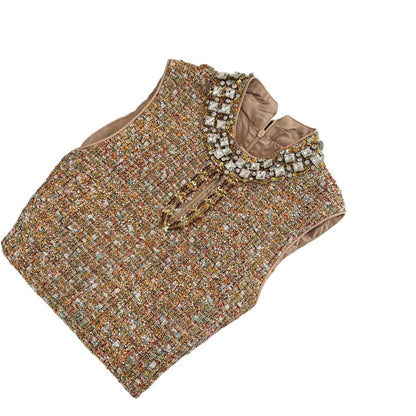 Платье без рукавов, расшитое бисером и приталенное.